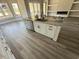 Modern kitchen island featuring a stainless steel sink, granite countertop, and sleek white cabinetry at 135 Bellwood Circle, Murrells Inlet, SC 29576