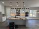 Modern kitchen featuring white cabinets, a large island, stainless steel appliances, and pendant lighting at 135 Low Country Loop, Murrells Inlet, SC 29576
