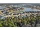 Aerial photograph showcasing a serene lake and surrounding homes in a residential area at 136 Starlit Way, Myrtle Beach, SC 29579