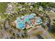 Aerial view showcasing a community pool and clubhouse surrounded by lush trees and landscaping at 136 Starlit Way, Myrtle Beach, SC 29579