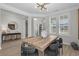 Bright dining area with natural light, a rustic wooden table, and contemporary seating for comfortable Gathering meals at 136 Starlit Way, Myrtle Beach, SC 29579