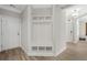 Inviting entryway with custom hall tree, white walls, and wood-look floors at 136 Starlit Way, Myrtle Beach, SC 29579