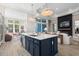 Bright kitchen with blue island, stainless appliances, and pendant lighting, flowing into a comfortable living space at 136 Starlit Way, Myrtle Beach, SC 29579