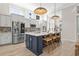 A modern kitchen with stainless steel appliances, a large island with seating, and ample natural light at 136 Starlit Way, Myrtle Beach, SC 29579