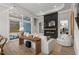 The bright living room features a modern fireplace, a large sliding glass door and contemporary furnishings at 136 Starlit Way, Myrtle Beach, SC 29579