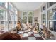 Light-filled sunroom with large windows, tiled flooring, and cozy furniture, creating a versatile and inviting space at 136 Starlit Way, Myrtle Beach, SC 29579