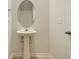 A pedestal sink with an oval mirror at 1369 Palm Springs Paloma Dr, Longs, SC 29568