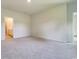 Spacious carpeted bedroom with doors leading to the hallway and bathroom at 1369 Palm Springs Paloma Dr, Longs, SC 29568