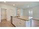Kitchen island featuring a stainless steel sink, granite countertop, white cabinetry and wood-look flooring at 1369 Palm Springs Paloma Dr, Longs, SC 29568