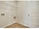 A laundry room with hookups, a door, and shelving at 1369 Palm Springs Paloma Dr, Longs, SC 29568