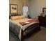 Bedroom with wooden bed frame with floral comforter, matched with furniture set at 1372 Oakmont Ct., Murrells Inlet, SC 29576