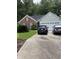 Charming single-story home featuring brick and siding exterior with well-maintained landscaping and a two car garage at 1372 Oakmont Ct., Murrells Inlet, SC 29576