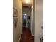 Well-lit hallway with hardwood floors, decorated with framed artwork, leading to other areas of the home at 1372 Oakmont Ct., Murrells Inlet, SC 29576