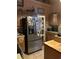 Functional kitchen featuring stainless steel refrigerator, ample cabinet space and an adjacent breakfast bar at 1372 Oakmont Ct., Murrells Inlet, SC 29576