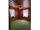 Bedroom featuring wood paneling and matching trim around two windows at 1375 Kenny Jordan Rd, Tabor City, NC 28463