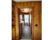 Hallway featuring wood-paneled walls and a view of the exterior, seamlessly connecting indoor and outdoor spaces at 1375 Kenny Jordan Rd, Tabor City, NC 28463