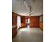 Kitchen with wood paneled walls, and view into another room at 1375 Kenny Jordan Rd, Tabor City, NC 28463