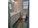 Bright bathroom featuring a white vanity with a sink and a toilet next to a window at 1501 Ferney Dr., Conway, SC 29526