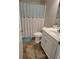 This bathroom features a shower with a decorative curtain and a vanity with a white countertop at 1501 Ferney Dr., Conway, SC 29526