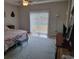 Bedroom with a sliding glass door to the outside, ceiling fan, and patterned quilt at 1501 Ferney Dr., Conway, SC 29526