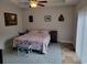 Cozy bedroom boasts a ceiling fan, patterned quilt, and serene decor for restful nights at 1501 Ferney Dr., Conway, SC 29526