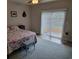 Bedroom with a sliding glass door to the outside, ceiling fan, and patterned quilt at 1501 Ferney Dr., Conway, SC 29526