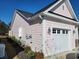 Side exterior showing the home's garage and utility hookups at 1501 Ferney Dr., Conway, SC 29526