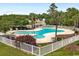 This community pool is surrounded by palm trees, a fence, and lounge chairs at 1501 Ferney Dr., Conway, SC 29526