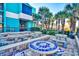 Outdoor patio with mosaic tables surrounded by lush landscaping and shade at 1501 S Ocean Blvd. # 844, Myrtle Beach, SC 29577