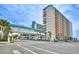 Exterior street-level view of the Landmark Resort, featuring an elevated covered walkway at 1501 S Ocean Blvd. # 844, Myrtle Beach, SC 29577