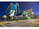 Night scene of Landmark Resort with illuminated signage, well-maintained landscaping, and inviting exterior architecture at 1501 S Ocean Blvd. # 844, Myrtle Beach, SC 29577