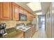 Functional kitchen featuring granite countertops, white appliances, and wood cabinets at 1501 S Ocean Blvd. # 844, Myrtle Beach, SC 29577