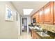 Efficient kitchen featuring wooden cabinets, stone countertops, an electric range, and stainless-steel appliances at 1501 S Ocean Blvd. # 844, Myrtle Beach, SC 29577