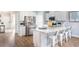 Bright kitchen featuring white cabinets, stainless steel appliances, a large island, and seamless access to other living areas at 1509 Seachase Way, North Myrtle Beach, SC 29582