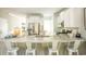 Open kitchen with stainless steel appliances, island seating, granite countertops, and seamless flow into adjacent living spaces at 1509 Seachase Way, North Myrtle Beach, SC 29582