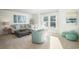 Bright living room featuring a beige sectional, ottoman and coastal decor, with shiplap walls, and a large window for natural light at 1509 Seachase Way, North Myrtle Beach, SC 29582