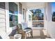 Relax on this porch in wicker chairs, overlooking lush greenery for peaceful outdoor enjoyment at 1509 Seachase Way, North Myrtle Beach, SC 29582