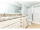 Bright bathroom featuring a double sink vanity, granite countertops, and a glass enclosed shower at 1614-B S Ocean Blvd., Surfside Beach, SC 29575