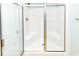 A bright bathroom features a shower with glass sliding door and white walls at 1614-B S Ocean Blvd., Surfside Beach, SC 29575