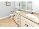 Well-lit bathroom featuring double vanity with granite countertop, framed seashell art, and tile flooring at 1614-B S Ocean Blvd., Surfside Beach, SC 29575