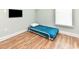 Bedroom with wood flooring featuring a twin size bed with metal frame, television, and natural light at 1614-B S Ocean Blvd., Surfside Beach, SC 29575