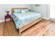 Comfortable bedroom featuring a queen-size bed with a decorative headboard and wood flooring at 1614-B S Ocean Blvd., Surfside Beach, SC 29575