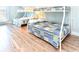 Bedroom with wood flooring featuring two bunk beds with white frames and patterned quilts at 1614-B S Ocean Blvd., Surfside Beach, SC 29575