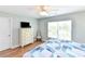 Bedroom featuring a dresser, window, wood floors and a bed with patterned comforter at 1614-B S Ocean Blvd., Surfside Beach, SC 29575
