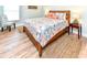 Bright bedroom with colorful bedding, chair, bedside tables with lamps, and light wood laminate flooring at 1614-B S Ocean Blvd., Surfside Beach, SC 29575