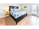 Well-lit bedroom features a queen-sized bed, a jute rug, and a sliding glass door to a balcony at 1614-B S Ocean Blvd., Surfside Beach, SC 29575