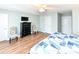 Spacious bedroom features a dark wood dresser, tv, ceiling fan, and two upholstered chairs at 1614-B S Ocean Blvd., Surfside Beach, SC 29575