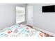Bedroom featuring a window, TV, and patterned comforter at 1614-B S Ocean Blvd., Surfside Beach, SC 29575