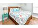 Bright bedroom with a wooden bed frame, decorative pillows and a window at 1614-B S Ocean Blvd., Surfside Beach, SC 29575