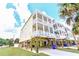 Low angle view of elevated beach home with multiple balconies near other elevated homes at 1614-B S Ocean Blvd., Surfside Beach, SC 29575